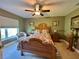 Comfortable bedroom with a floral-patterned bedspread, bedside tables, and large window at 745 Aldenham Ln, Ormond Beach, FL 32174