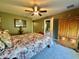 Cozy bedroom with floral bedding, armoire, and soft, natural lighting, creating a relaxing atmosphere at 745 Aldenham Ln, Ormond Beach, FL 32174