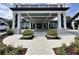 Clubhouse entrance featuring covered parking and a walkway with planters at 745 Aldenham Ln, Ormond Beach, FL 32174