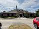 Exterior view of the community clubhouse showing brick exterior with dormers at 745 Aldenham Ln, Ormond Beach, FL 32174