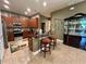 Charming kitchen featuring granite counters, wood cabinets and bar seating, ideal for casual dining at 745 Aldenham Ln, Ormond Beach, FL 32174