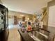 Open-concept kitchen with granite countertops flows seamlessly into the dining and living areas at 745 Aldenham Ln, Ormond Beach, FL 32174