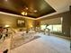 Spacious living room with dark coffered ceiling, plush sofa, and large window at 745 Aldenham Ln, Ormond Beach, FL 32174