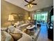 Cozy living room with neutral tones, comfortable seating, and a ceiling fan at 745 Aldenham Ln, Ormond Beach, FL 32174