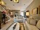 Cozy living room with couches, staircase, and a view of the dining area at 745 Aldenham Ln, Ormond Beach, FL 32174