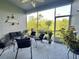 A screened-in patio is furnished with seating, potted plants, and overlooks a lush landscape at 745 Aldenham Ln, Ormond Beach, FL 32174