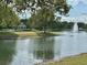Picturesque community pond with a fountain and a charming gazebo in the background at 745 Aldenham Ln, Ormond Beach, FL 32174