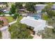 Aerial shot showcases a home with a screened-in pool, lush backyard, and proximity to neighboring residences at 11 Larisa Ter, Ormond Beach, FL 32174