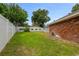 Back yard with well-maintained lawn, privacy fence, and access to screened-in porch at 11 Larisa Ter, Ormond Beach, FL 32174