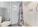 Bathroom featuring a tiled shower with built-in niche, toilet, and access to the backyard through a glass door at 11 Larisa Ter, Ormond Beach, FL 32174