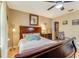 Comfortable bedroom featuring a dark wooden bed frame, ceiling fan, and ample natural light at 11 Larisa Ter, Ormond Beach, FL 32174