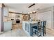 Modern kitchen featuring an island with barstool seating, stainless steel appliances, and tile flooring at 11 Larisa Ter, Ormond Beach, FL 32174