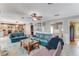 Spacious living room with large sofas, a ceiling fan, and an open view to the kitchen at 11 Larisa Ter, Ormond Beach, FL 32174