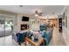 Open-concept living room featuring a stone fireplace and an easy flow into the kitchen area at 11 Larisa Ter, Ormond Beach, FL 32174