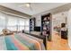 Bright main bedroom showcasing a bay window, built-in bookshelves, and access to an adjacent office space at 11 Larisa Ter, Ormond Beach, FL 32174