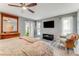 Bright bedroom with wood-look floors, ceiling fan, patio access, and a large antique mirror at 11 Larisa Ter, Ormond Beach, FL 32174