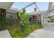 Lush landscaping surrounds brick home, leading to a covered patio, perfect for outdoor relaxation at 11 Larisa Ter, Ormond Beach, FL 32174