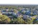 A community aerial view shows lush green spaces, trees, and a pond nearby, with parking and sidewalks at 133 Blue Heron Dr # C, Daytona Beach, FL 32119