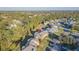 An aerial shot shows the building surrounded by a dense canopy of trees in a picturesque neighborhood at 133 Blue Heron Dr # C, Daytona Beach, FL 32119
