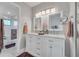 Bathroom with a double sink vanity, two mirrors, sleek fixtures, and a glass shower at 133 Blue Heron Dr # C, Daytona Beach, FL 32119