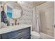 Bathroom featuring modern fixtures, a stylish wallpaper, and a tub with shower at 133 Blue Heron Dr # C, Daytona Beach, FL 32119