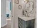 Stylish bathroom with neutral wallpaper, a round mirror, and contemporary fixtures at 133 Blue Heron Dr # C, Daytona Beach, FL 32119