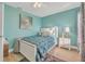 Cozy bedroom with aqua walls, white furniture, and a ceiling fan at 133 Blue Heron Dr # C, Daytona Beach, FL 32119