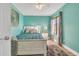 Bright bedroom with neutral decor, a ceiling fan, and a large window with decorative curtains at 133 Blue Heron Dr # C, Daytona Beach, FL 32119