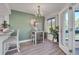 Bright dining area features a stylish chandelier, a bar-height table, and an accent wall at 133 Blue Heron Dr # C, Daytona Beach, FL 32119
