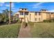 Inviting townhome with a well-manicured lawn and trimmed bushes lining the walkway at 133 Blue Heron Dr # C, Daytona Beach, FL 32119