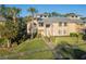 Attractive townhouse featuring lush landscaping, mature palm trees, and a welcoming front entrance at 133 Blue Heron Dr # C, Daytona Beach, FL 32119