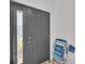 Stylish black front door with a sidelight window, complemented by a white wall at 133 Blue Heron Dr # C, Daytona Beach, FL 32119