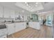 Bright kitchen with white cabinets, granite countertops, stainless steel appliances, and modern lighting at 133 Blue Heron Dr # C, Daytona Beach, FL 32119
