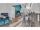 Bright living room with vaulted ceiling, blue accent wall, and modern furnishings at 133 Blue Heron Dr # C, Daytona Beach, FL 32119