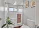 Glass-enclosed shower with white tile, a bench, and sleek fixtures at 133 Blue Heron Dr # C, Daytona Beach, FL 32119