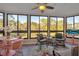 Relaxing sun room filled with natural light, wicker chairs, and views of the lush green surroundings at 133 Blue Heron Dr # C, Daytona Beach, FL 32119