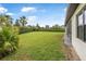 Spacious backyard featuring lush green grass, mature landscaping, and a well-maintained lawn at 1357 Liam Cir, Ormond Beach, FL 32174