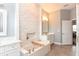 Elegant bathroom featuring a soaking tub, vanity and an accent wall at 1357 Liam Cir, Ormond Beach, FL 32174