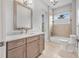 Bathroom features a neutral vanity, marble countertop, tile floor, and shower-tub combo with a window at 1357 Liam Cir, Ormond Beach, FL 32174