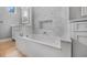 Bathroom with soaking tub and textured accent wall at 1357 Liam Cir, Ormond Beach, FL 32174