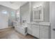Spa-like bathroom with double vanities, soaking tub, and textured accent wall at 1357 Liam Cir, Ormond Beach, FL 32174