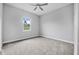 Bright bedroom features soft gray walls, carpet floors and a view of lush greenery at 1357 Liam Cir, Ormond Beach, FL 32174
