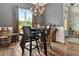 The dining area features modern seating, decor, wood floors, and a window view at 1357 Liam Cir, Ormond Beach, FL 32174