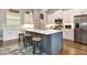 The kitchen features a center island with barstool seating and stainless steel appliances at 1357 Liam Cir, Ormond Beach, FL 32174