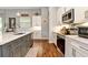 Well-appointed kitchen with two-tone cabinets, stainless appliances, marble countertops and luxury flooring at 1357 Liam Cir, Ormond Beach, FL 32174