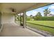 Relaxing screened lanai with a ceiling fan and scenic views of the lush backyard at 1357 Liam Cir, Ormond Beach, FL 32174