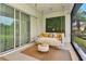Comfortable lanai featuring a swing, throw pillows and decorative green wall at 1357 Liam Cir, Ormond Beach, FL 32174