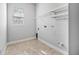 Clean laundry room with tile flooring, shelving, and a window, perfect for household chores at 1357 Liam Cir, Ormond Beach, FL 32174