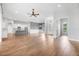 Open-concept living room with hardwood floors, flowing into the kitchen area at 1357 Liam Cir, Ormond Beach, FL 32174