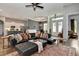 Cozy living room with large sectional sofa, stylish decor, and open layout to kitchen at 1357 Liam Cir, Ormond Beach, FL 32174